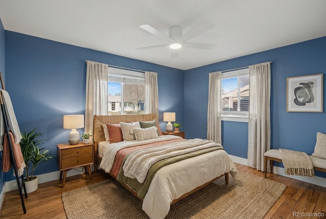 2580 South Perry Street Denver, CO 80219 - Photo 11 of 28 a bedroom with a bed a lamp and a large window