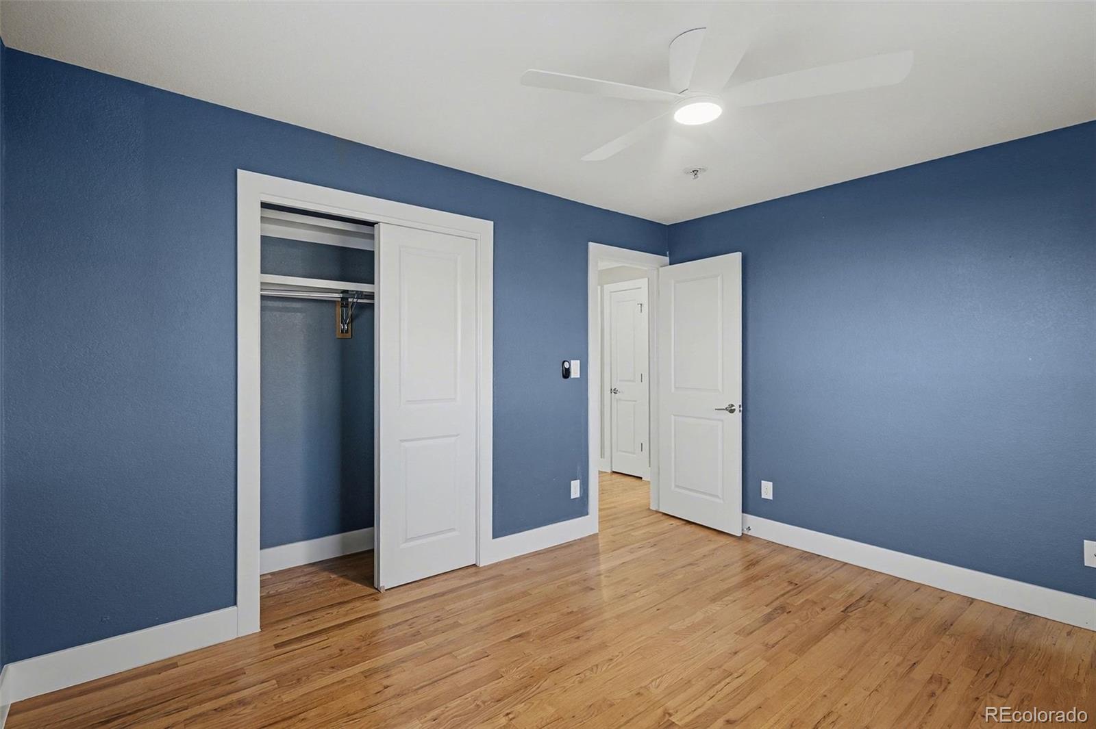 2580 South Perry Street Denver, CO 80219 - Photo 12 of 28 a view of empty room with wooden floor
