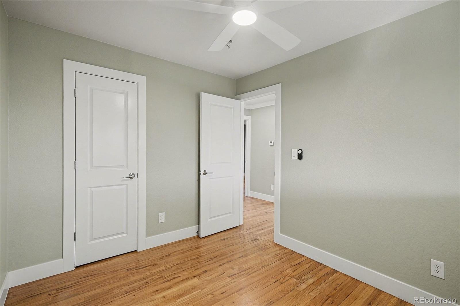 2580 South Perry Street Denver, CO 80219 - Photo 14 of 28 a view of an empty room and wooden floor