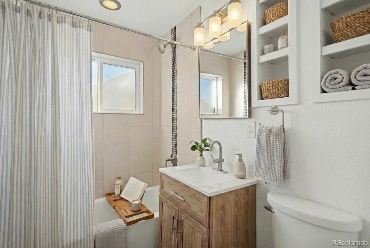 2580 South Perry Street Denver, CO 80219 - Photo 15 of 28 a bathroom with a sink toilet and vanity