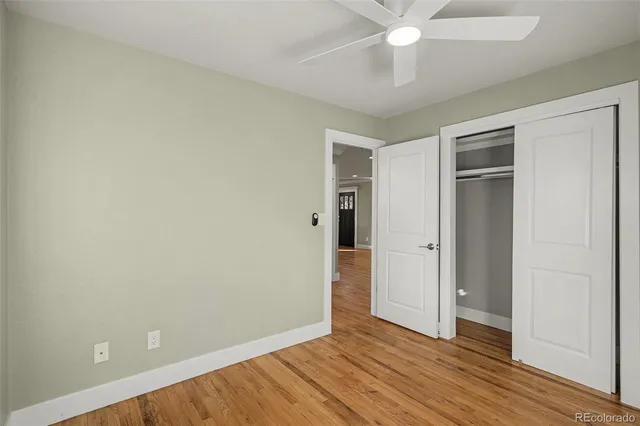 an empty room with wooden floor and door