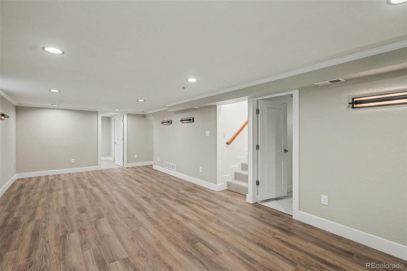2580 South Perry Street Denver, CO 80219 - Photo 19 of 28 a view of an empty room with wooden floor and a window