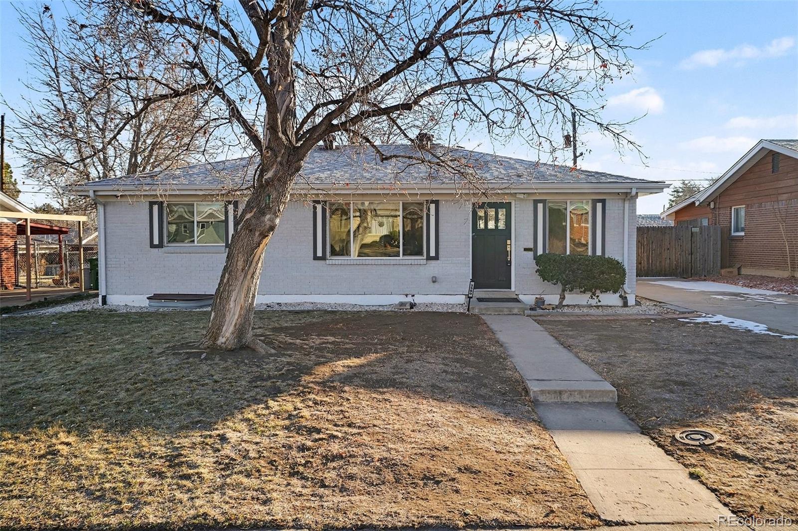 2580 South Perry Street Denver, CO 80219 - Photo 2 of 28 a front view of a house with a yard