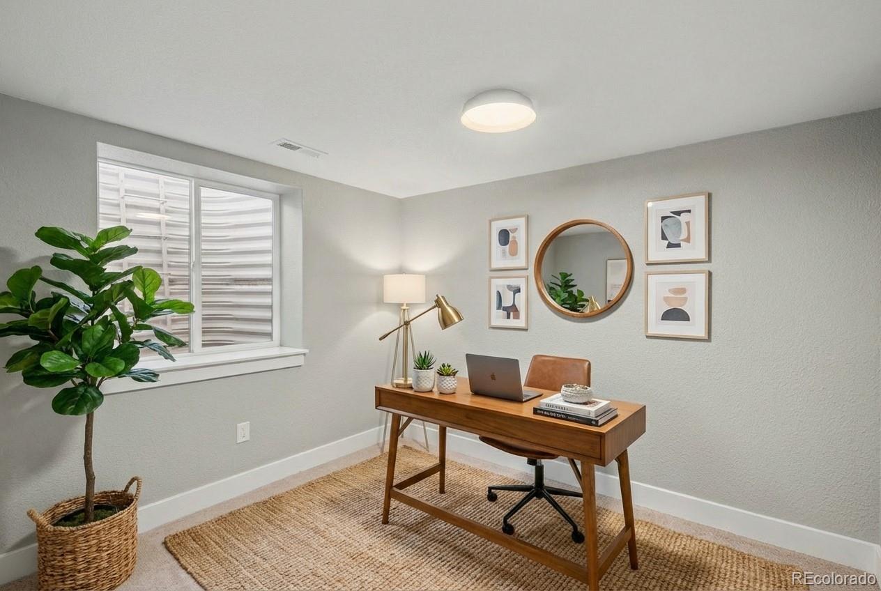 2580 South Perry Street Denver, CO 80219 - Photo 21 of 28 a view of a workspace with a table and a potted plant