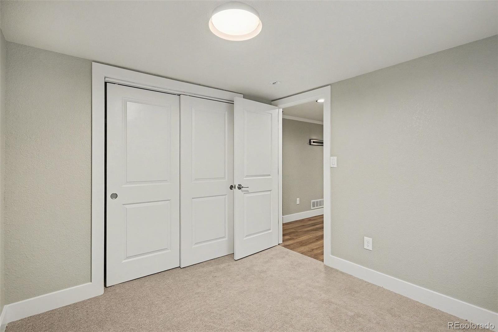 2580 South Perry Street Denver, CO 80219 - Photo 22 of 28 an empty room with closet area