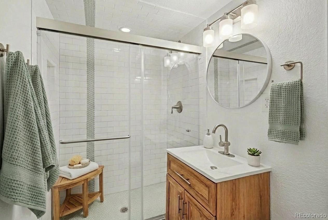 2580 South Perry Street Denver, CO 80219 - Photo 23 of 28 a bathroom with a sink vanity and a mirror