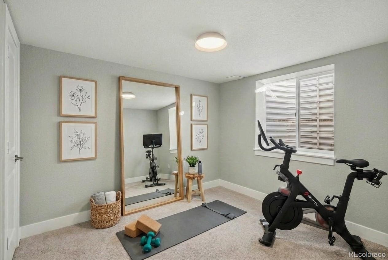 2580 South Perry Street Denver, CO 80219 - Photo 24 of 28 a room with gym equipment and windows