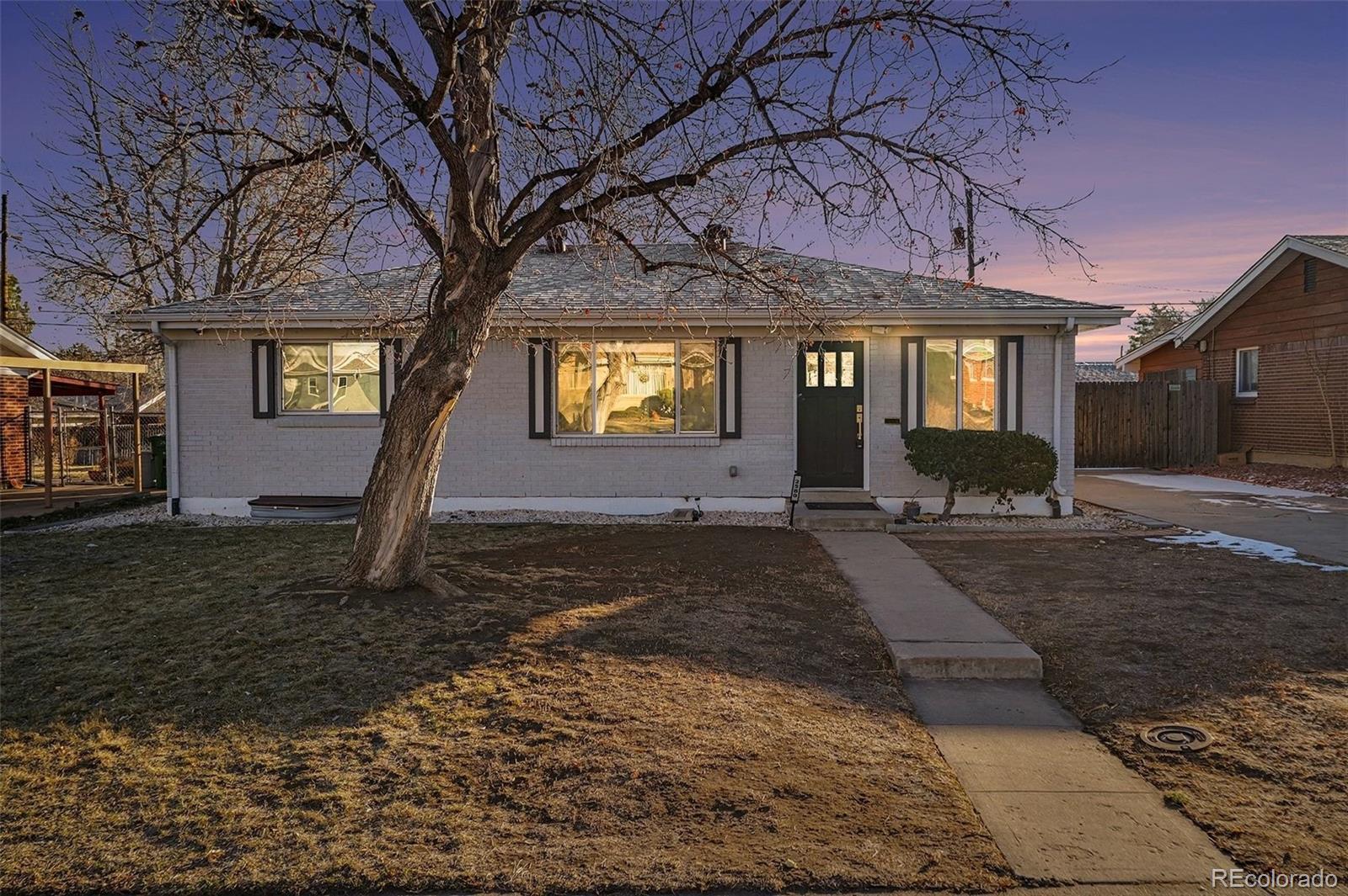 2580 South Perry Street Denver, CO 80219 - Photo 26 of 28 a front view of a house with garden
