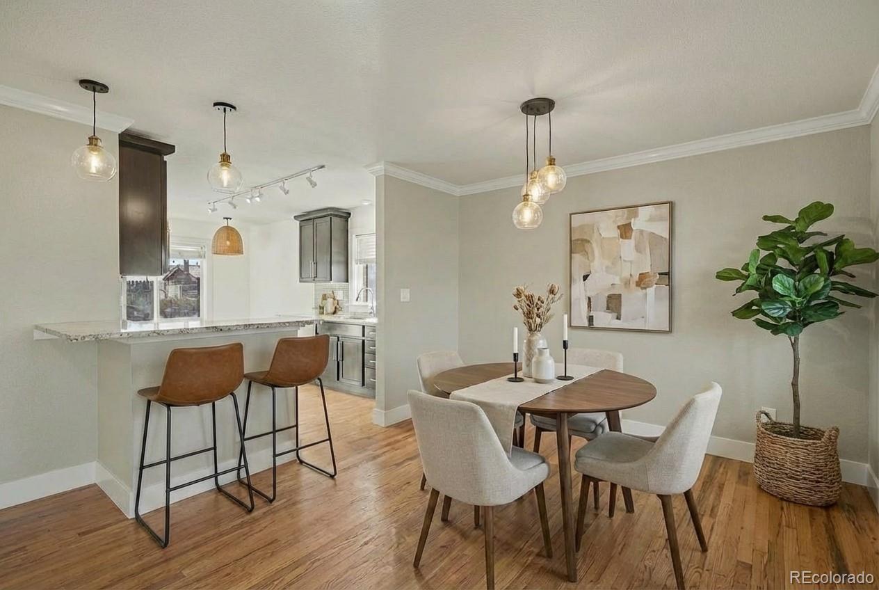 2580 South Perry Street Denver, CO 80219 - Photo 4 of 28 a view of a dining room with furniture and wooden floor