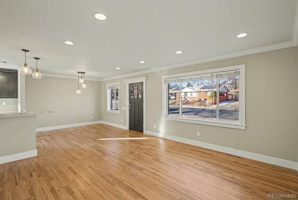 2580 South Perry Street Denver, CO 80219 - Photo 5 of 28 a view of livingroom with wooden floor and window