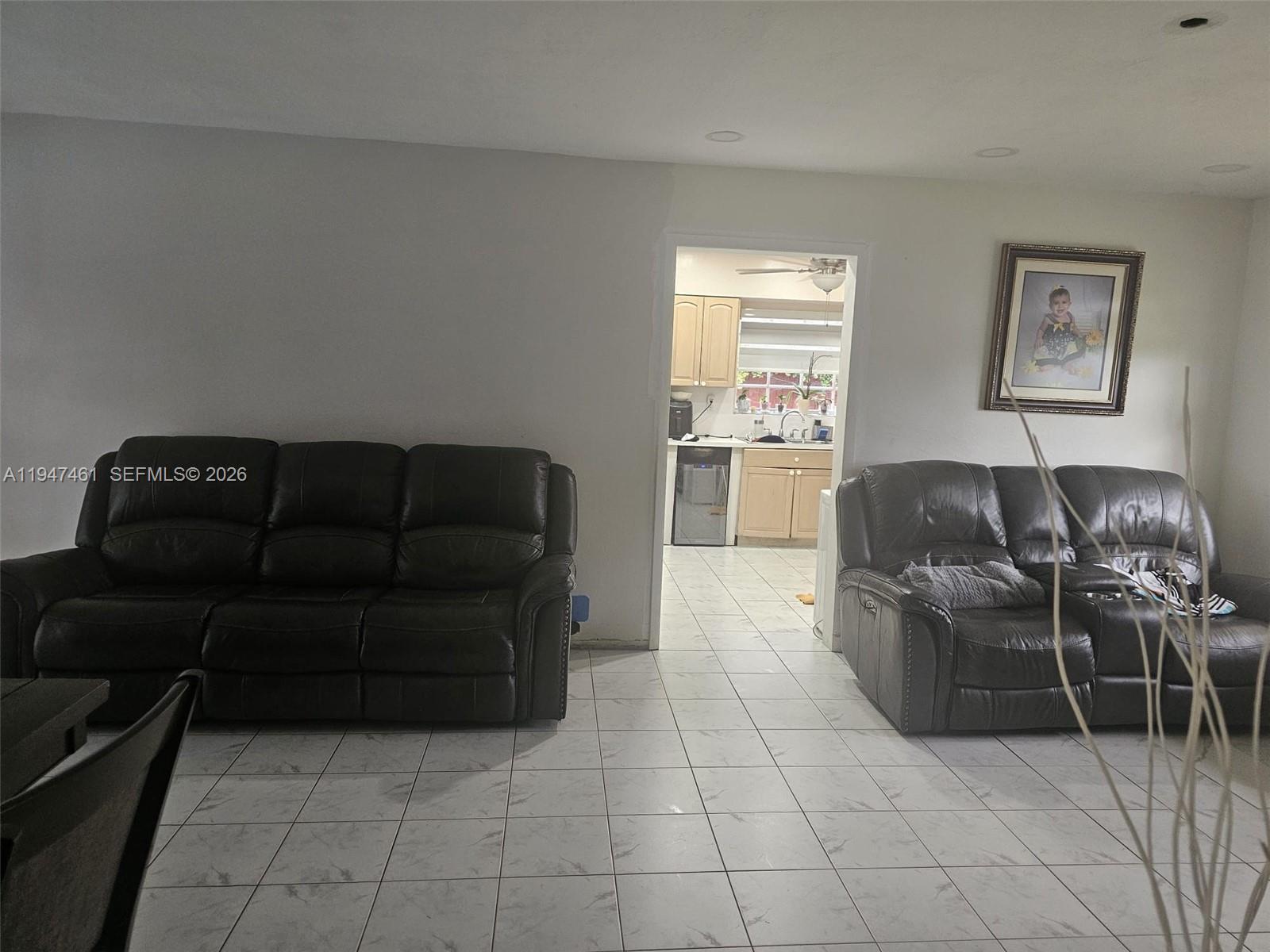 8930 Southwest 197th Terrace Cutler Bay, FL 33157 - Photo 2 of 10 a living room with furniture and a flat screen tv