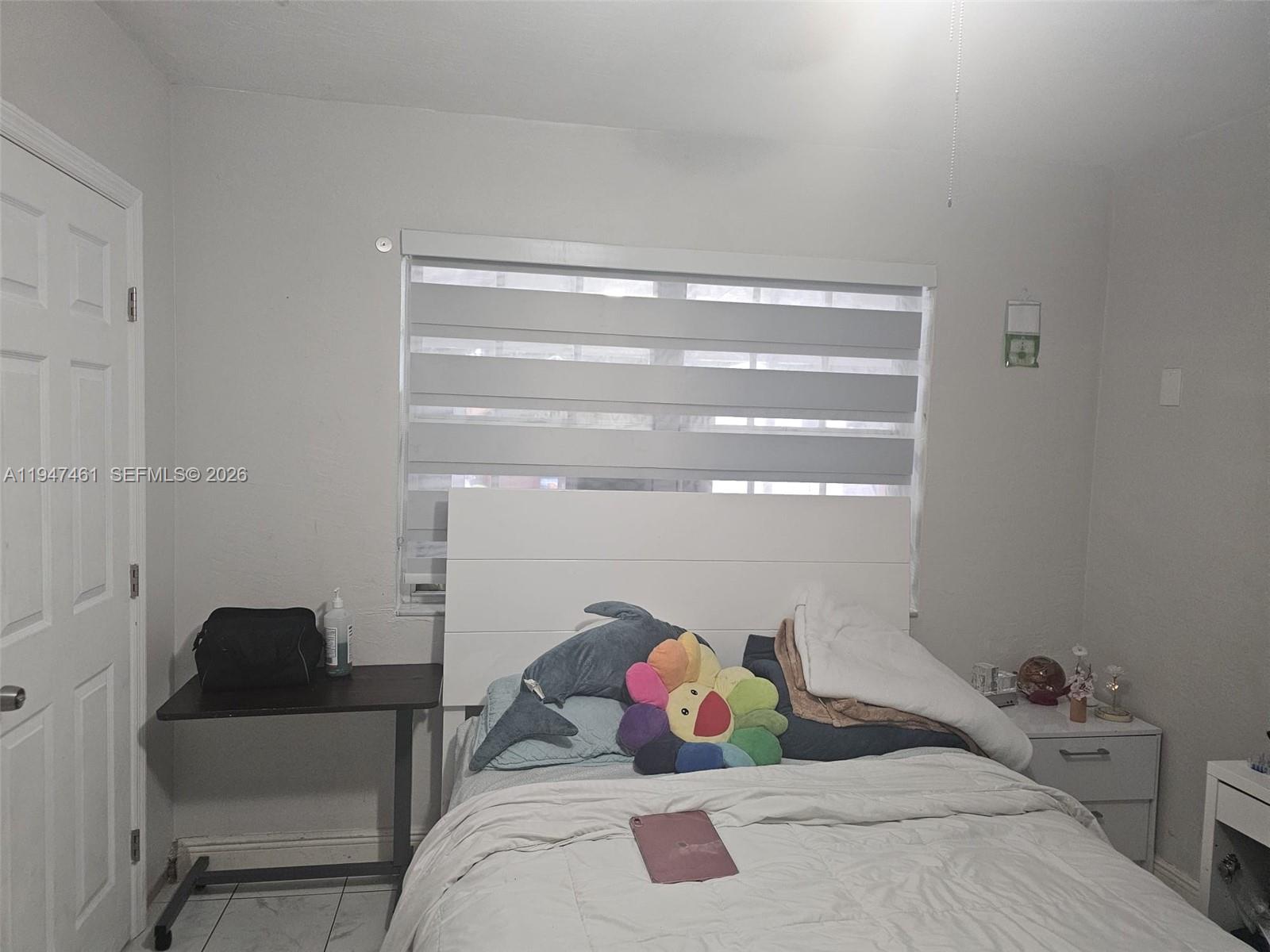 8930 Southwest 197th Terrace Cutler Bay, FL 33157 - Photo 7 of 10 a bedroom with a bed and closet