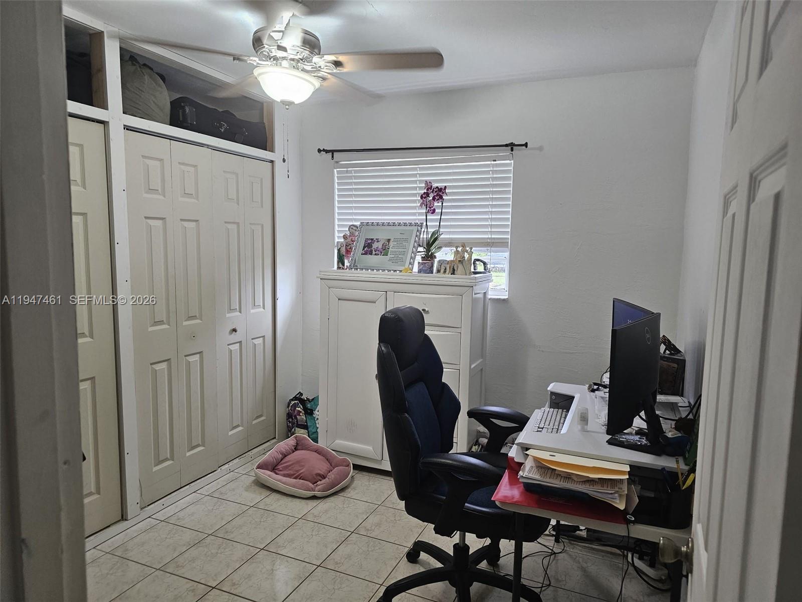 8930 Southwest 197th Terrace Cutler Bay, FL 33157 - Photo 8 of 10 a workspace with furniture and wooden floor