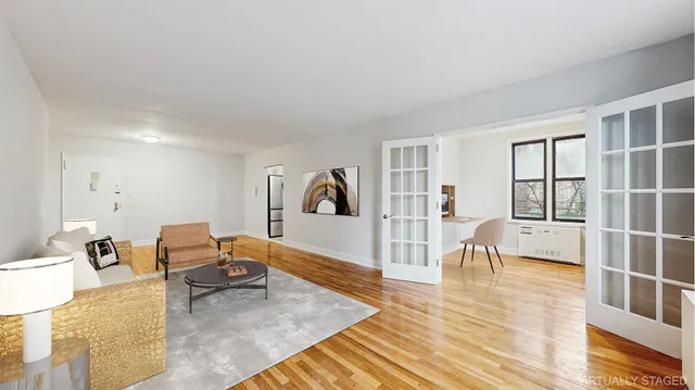 a living room with furniture a couch and a large window