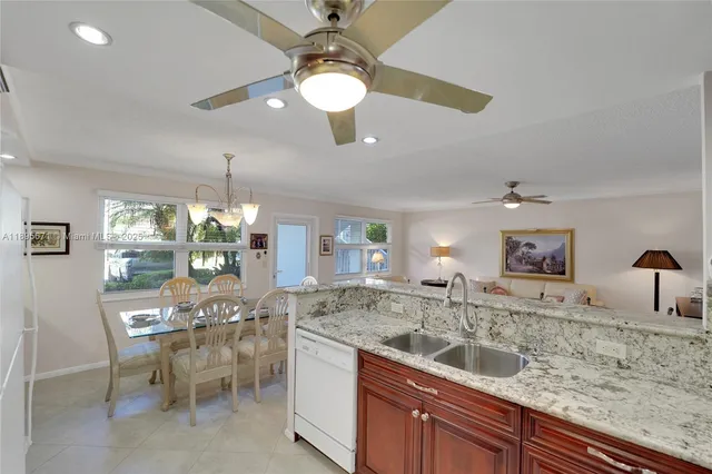 a kitchen with a sink stove cabinets and refrigerator