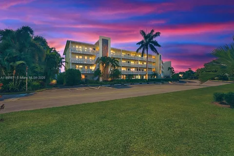 a view of a building with snow on the road