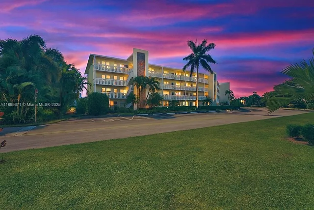 a view of a building with snow on the road