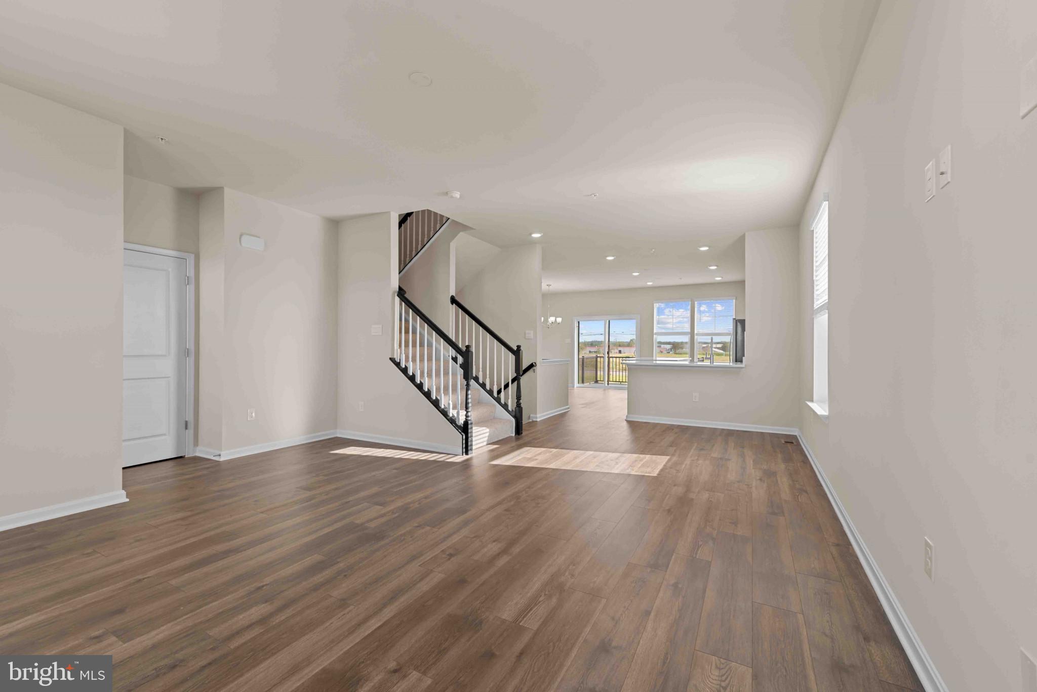 377 Ensemble Way Frederick, MD 21701 - Photo 17 of 45 wooden floor in an empty room with a window