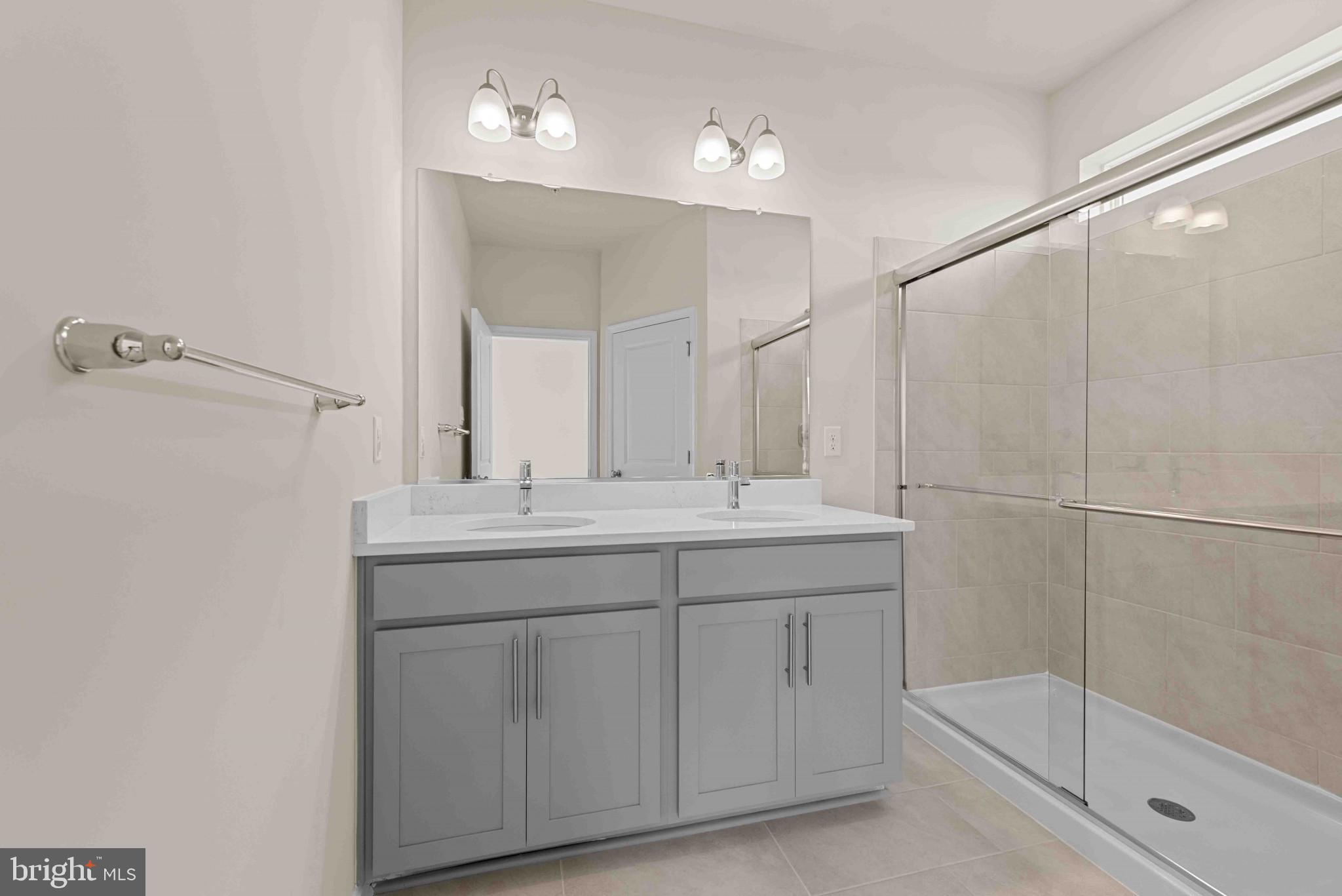 377 Ensemble Way Frederick, MD 21701 - Photo 29 of 45 a bathroom with a shower sink and mirror