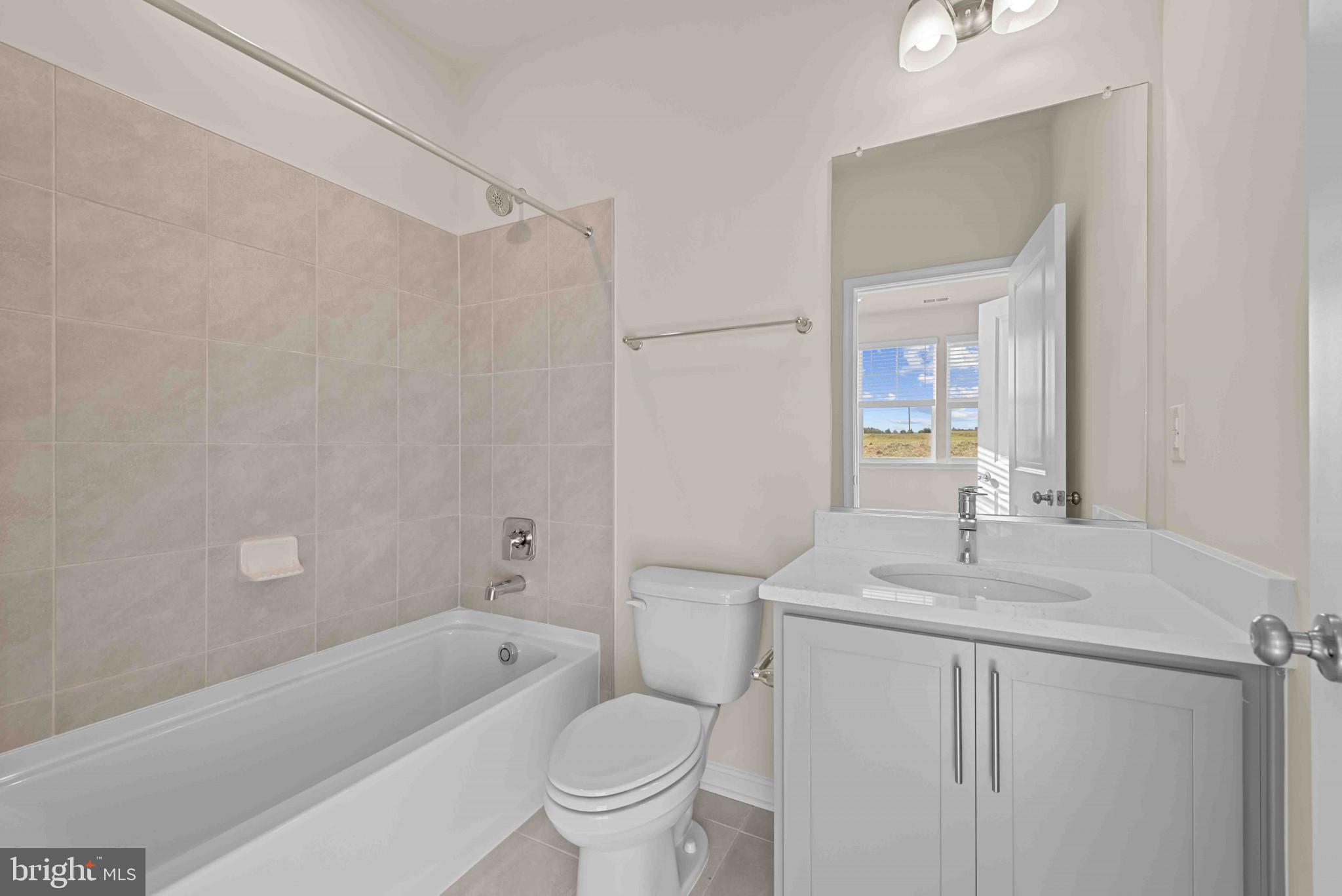 377 Ensemble Way Frederick, MD 21701 - Photo 5 of 45 a bathroom with a sink a toilet and a bathtub