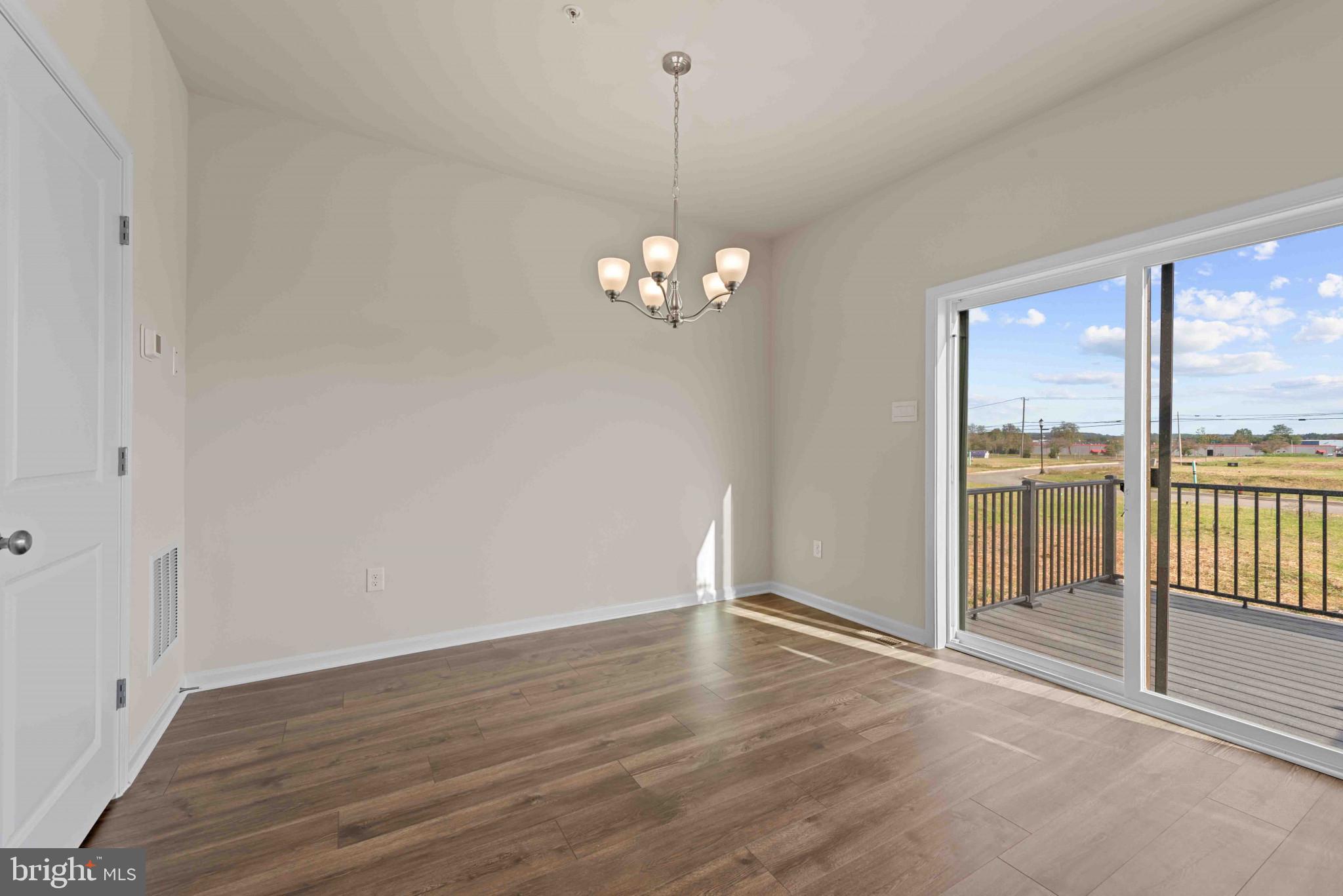 377 Ensemble Way Frederick, MD 21701 - Photo 6 of 45 a view of a room with wooden floor and large windows