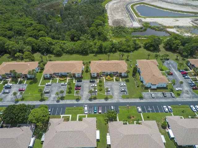 an aerial view of residential houses with outdoor space and swimming pool
