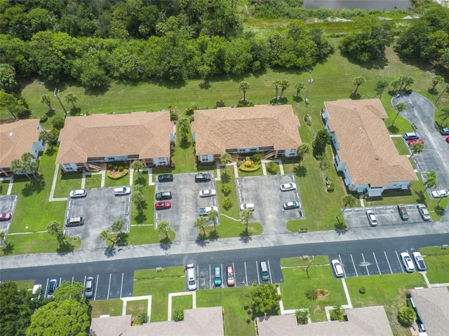 an aerial view of residential houses with outdoor space and river