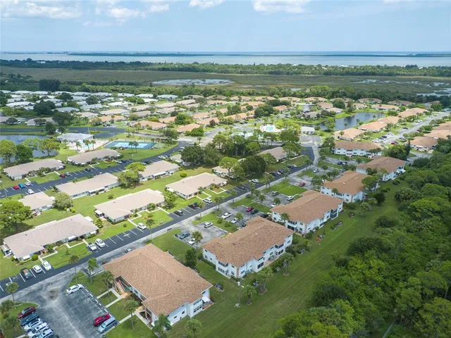 an aerial view of lake residential houses with outdoor space and lakeside