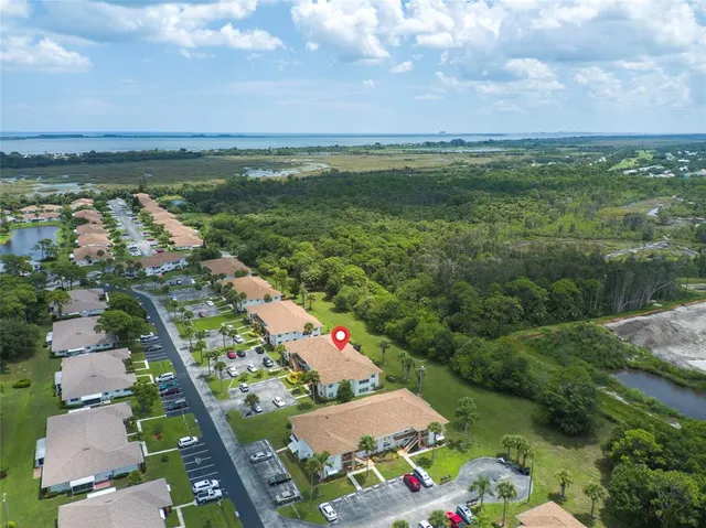 an aerial view of residential houses with outdoor space and trees