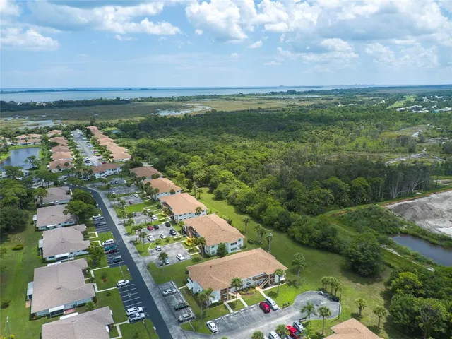 an aerial view of a house with garden space and street view