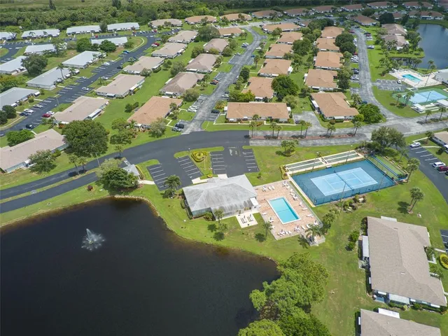 an aerial view of residential houses with outdoor space and river