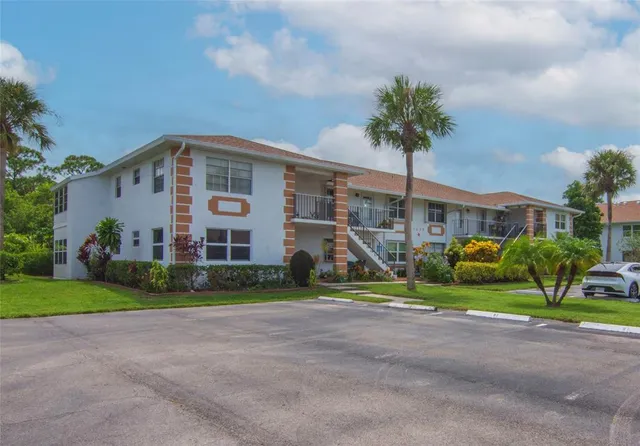 a kitchen with granite countertop a refrigerator and a stove top oven