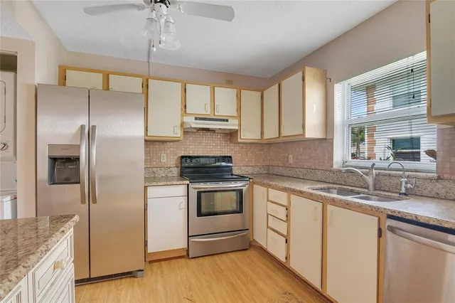 a kitchen with stainless steel appliances granite countertop a sink and a granite counter tops