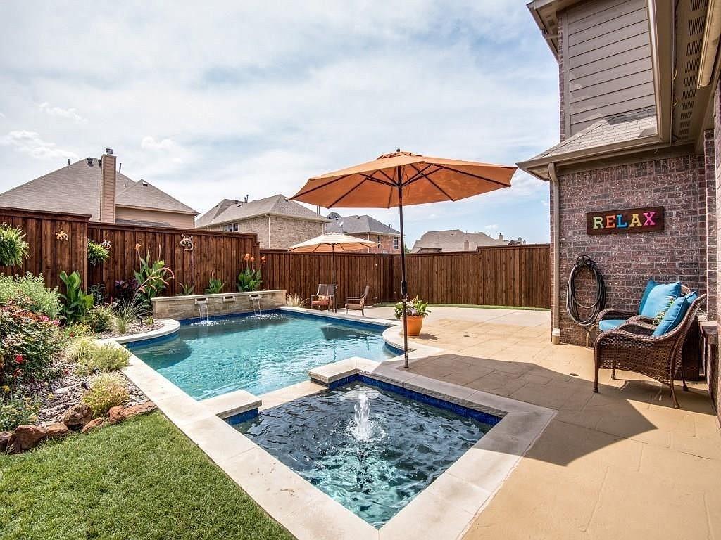 a view of a backyard with a patio and outdoor seating