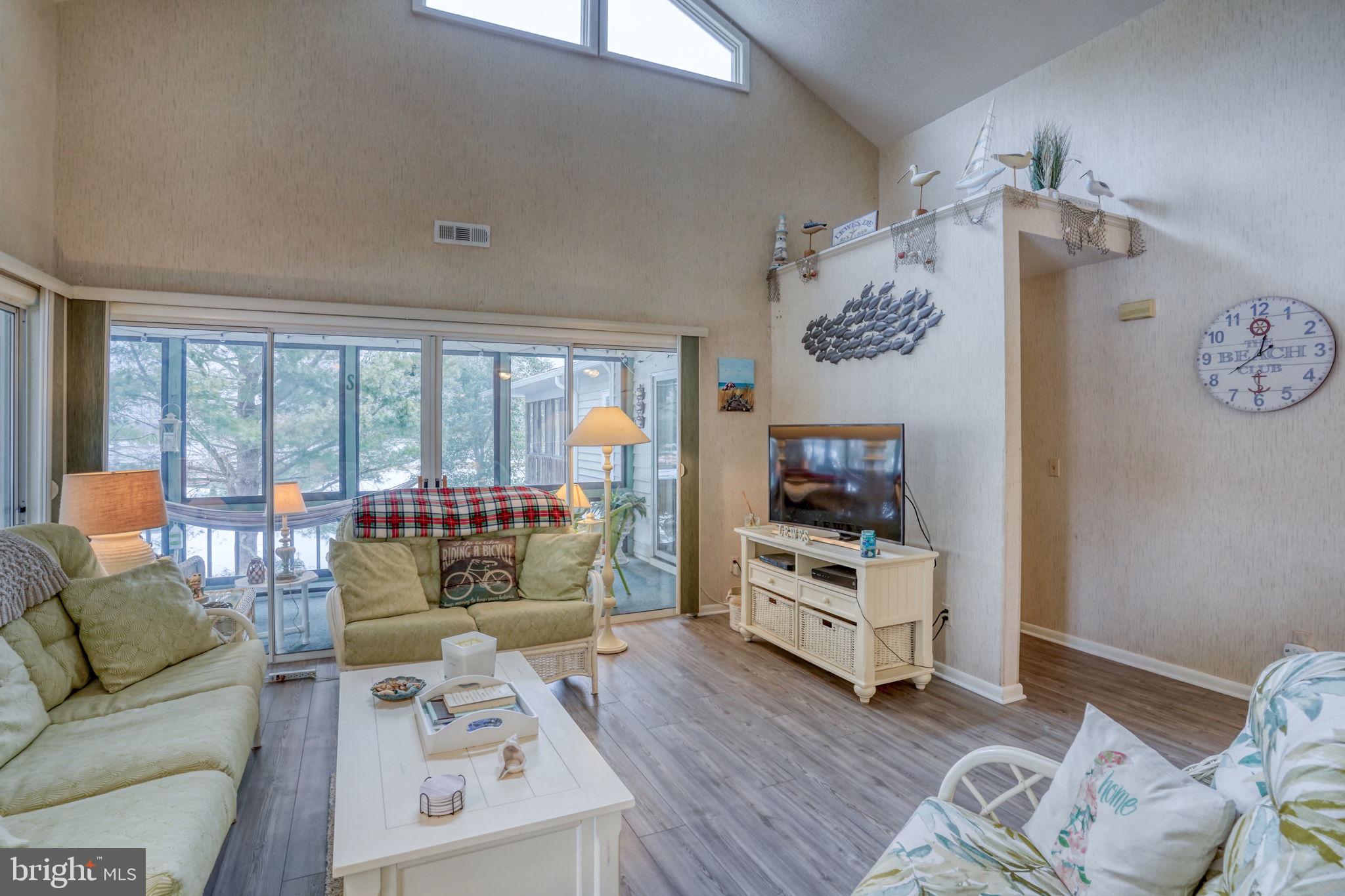 18488 Belle Grove Road, Unit 3 Lewes, DE 19958 - Photo 11 of 48 a living room with furniture and a flat screen tv