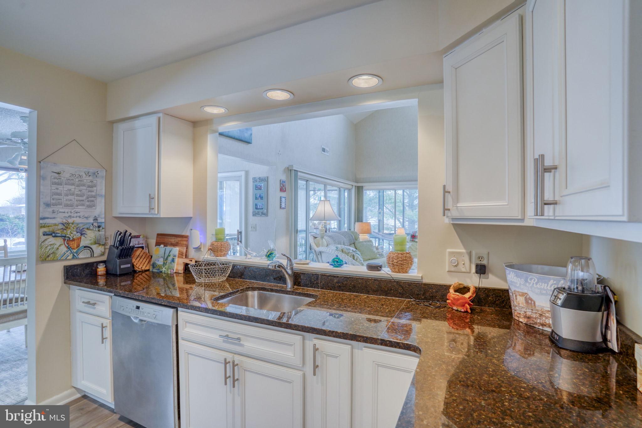 18488 Belle Grove Road, Unit 3 Lewes, DE 19958 - Photo 18 of 48 a kitchen with a sink stove and cabinets
