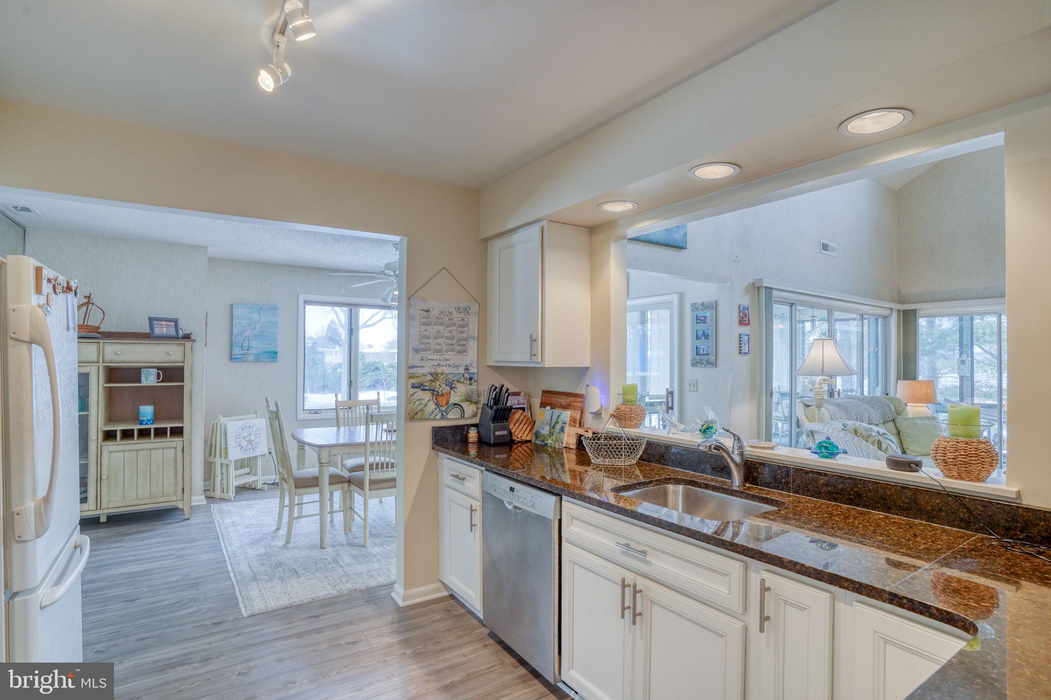 18488 Belle Grove Road, Unit 3 Lewes, DE 19958 - Photo 19 of 48 a kitchen with lots of counter top space and dining table