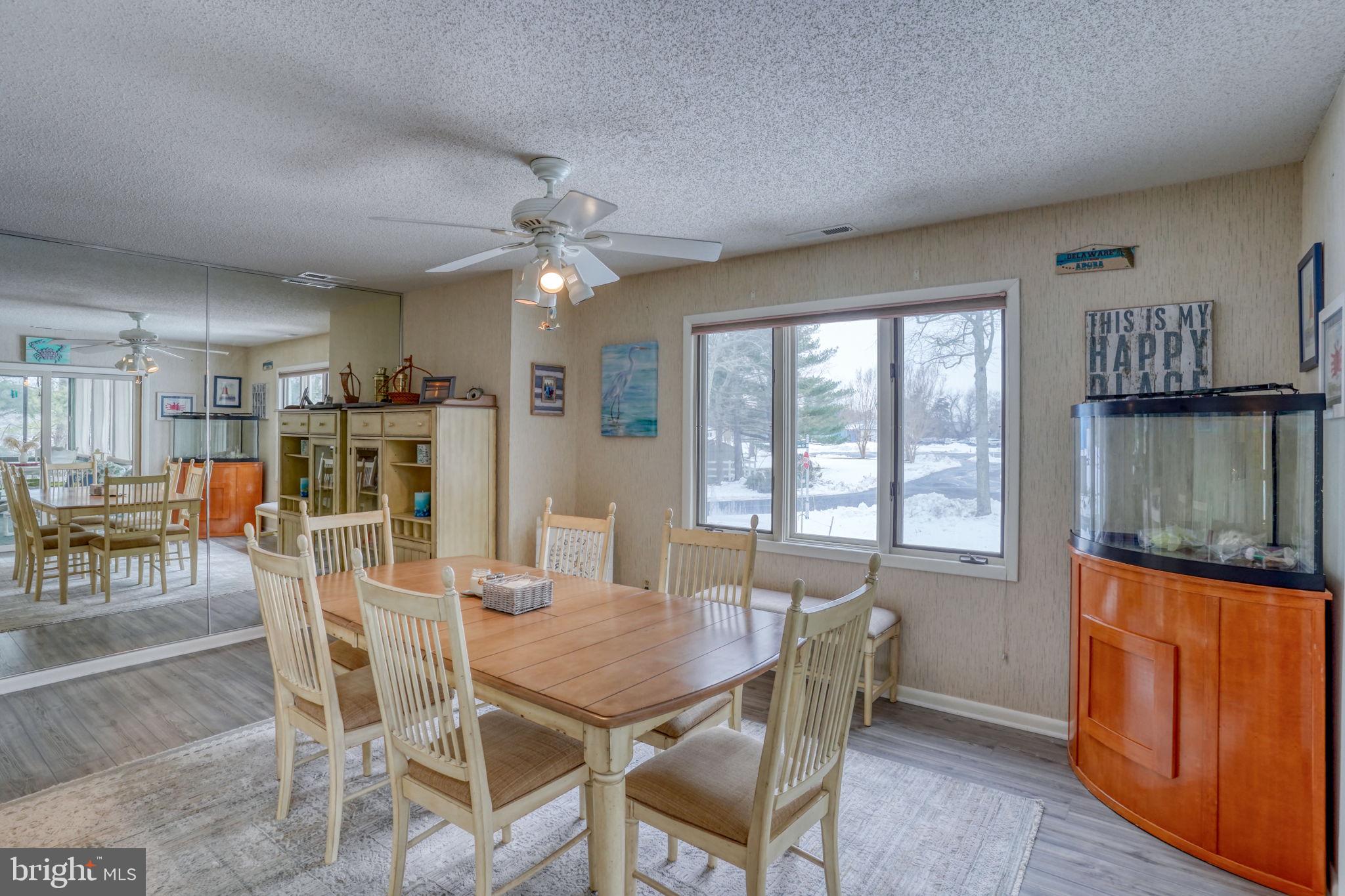 18488 Belle Grove Road, Unit 3 Lewes, DE 19958 - Photo 22 of 48 a view of a dining room with furniture window and wooden floor