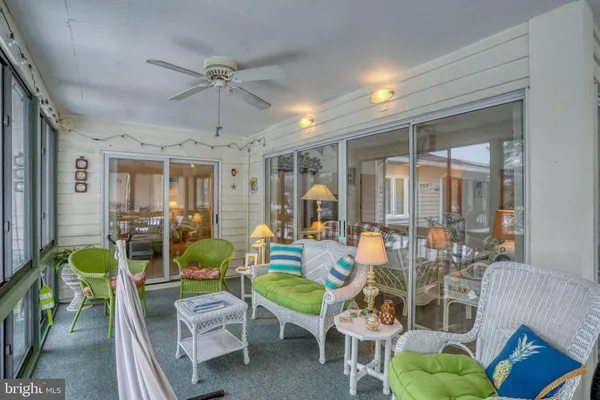 a living room with furniture a chandelier and a dining table