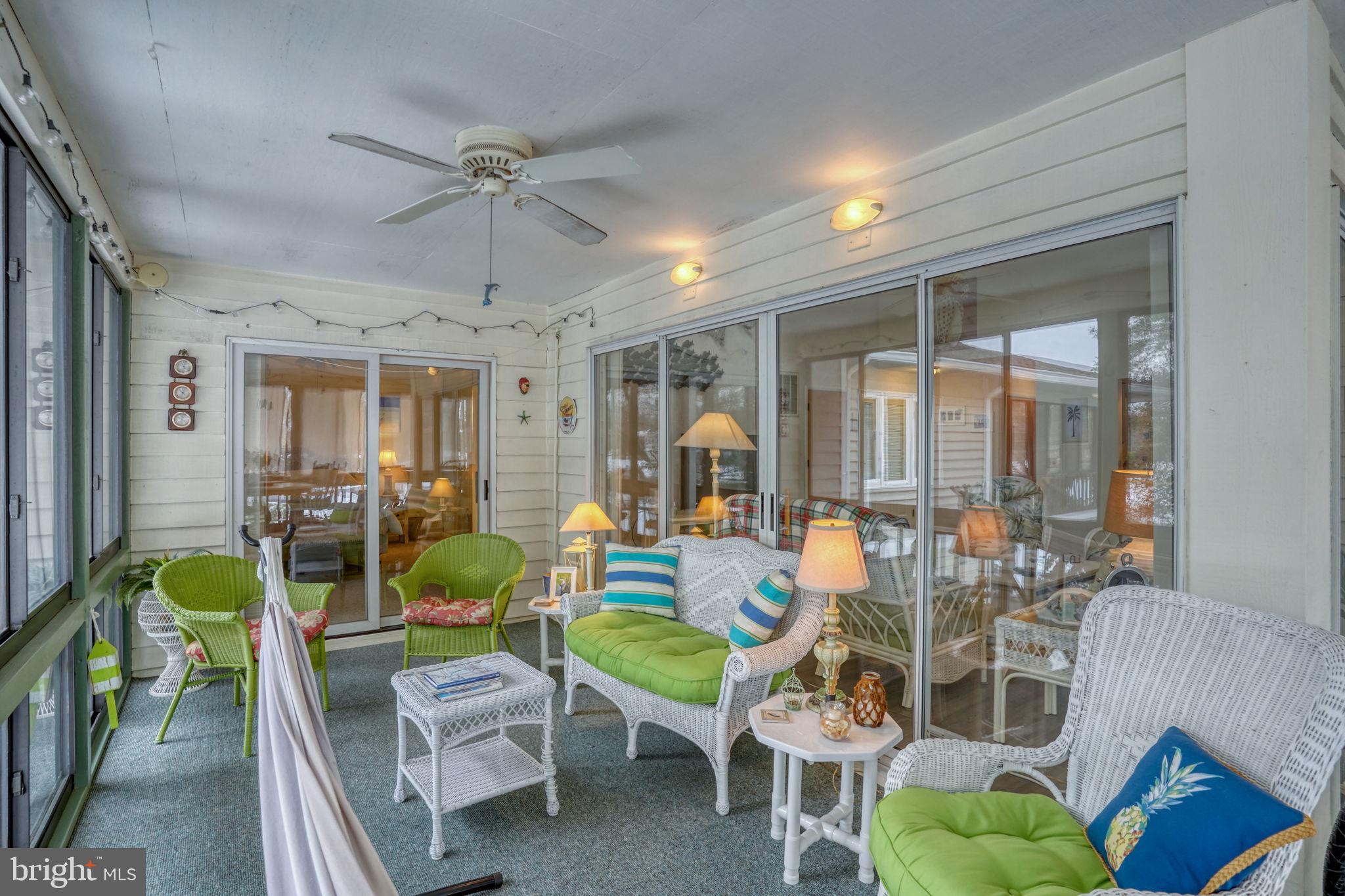 18488 Belle Grove Road, Unit 3 Lewes, DE 19958 - Photo 26 of 48 a living room with furniture a chandelier and a dining table