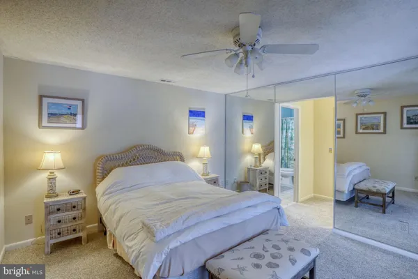 a bedroom with a bed and ceiling fan