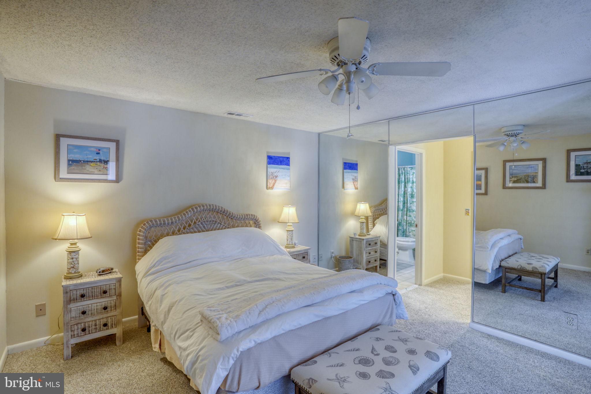 18488 Belle Grove Road, Unit 3 Lewes, DE 19958 - Photo 30 of 48 a bedroom with a bed and ceiling fan