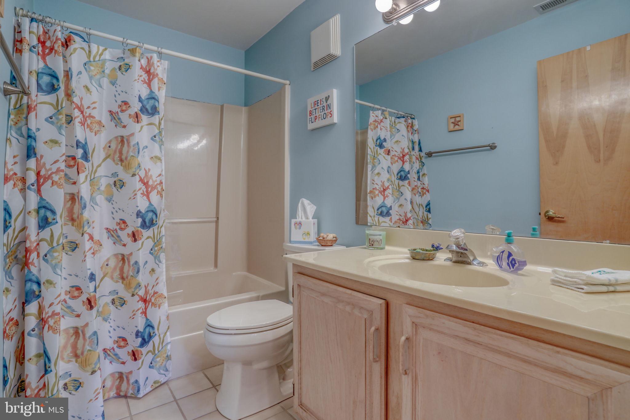 18488 Belle Grove Road, Unit 3 Lewes, DE 19958 - Photo 42 of 48 a bathroom with a sink toilet and shower