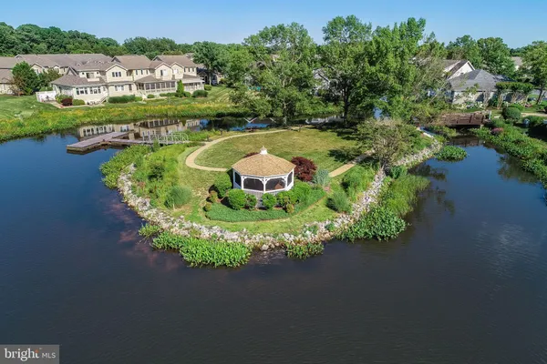 an aerial view of a house with a garden and lake view