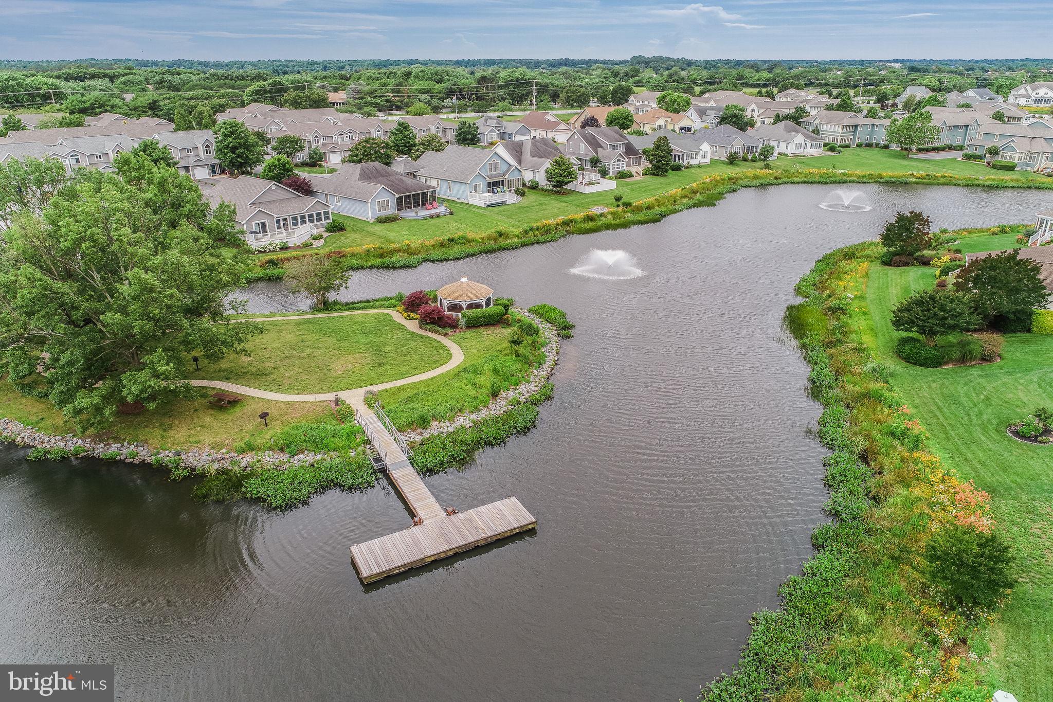 18488 Belle Grove Road, Unit 3 Lewes, DE 19958 - Photo 48 of 48 an aerial view of a house with a yard and lake view