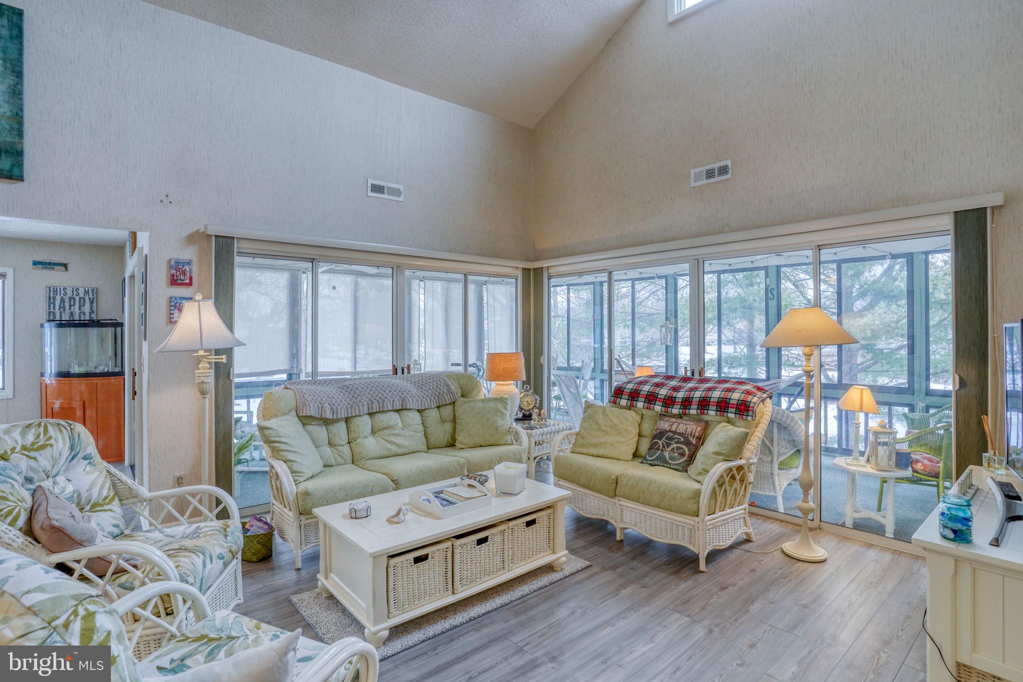 18488 Belle Grove Road, Unit 3 Lewes, DE 19958 - Photo 10 of 48 a living room with furniture and a large window