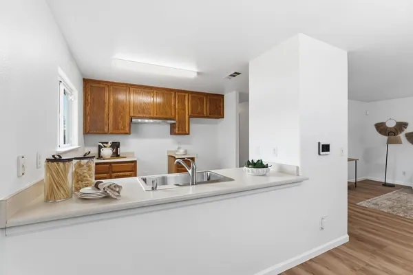 a kitchen with stainless steel appliances granite countertop a sink and cabinets