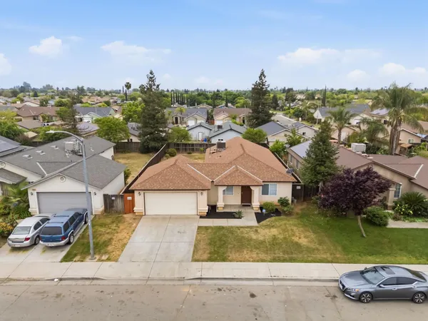 an aerial view of a house with garden space and ocean view
