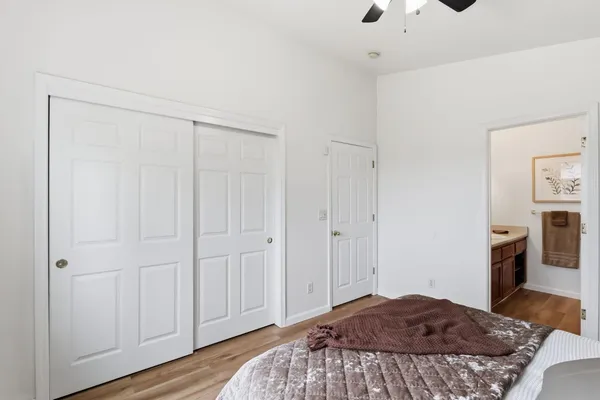 a bedroom with a bed and hallway