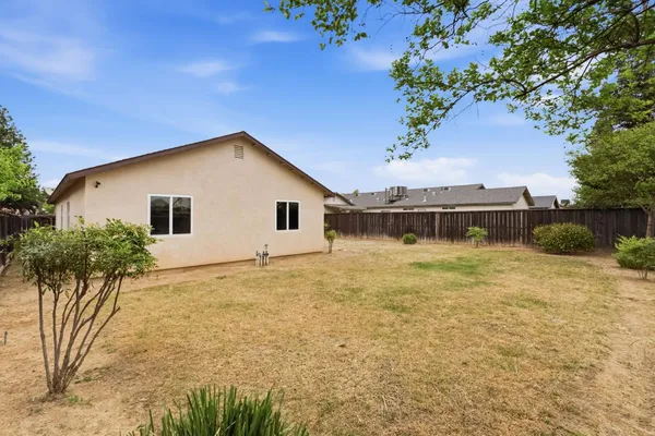 a view of a house with a backyard